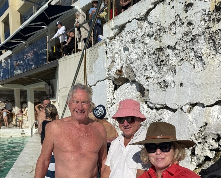 Friends gathered poolside at Bondi Icebergs on a sunny morning